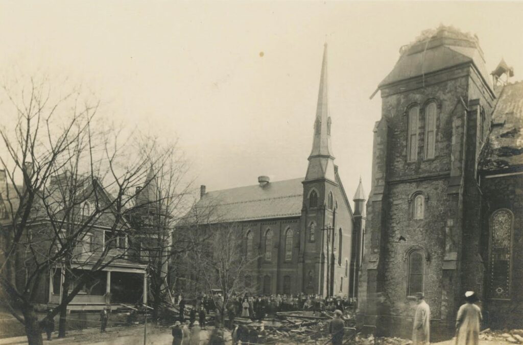 Residents looked at the remains of the church steeple that blew down during a 1913 storm. It was never replaced. (Joan