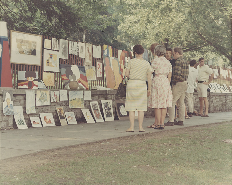 During the early years, artists displayed their work on a makeshift fence set up along College Avenue. (Penn State
