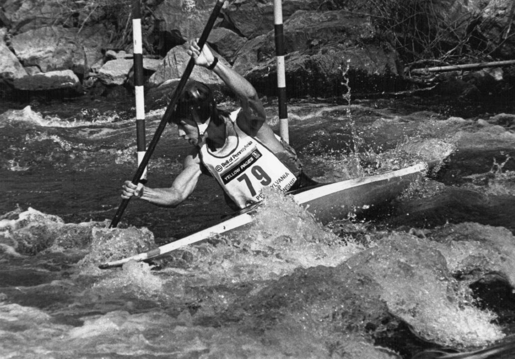 A kayak racer competes in a slalom race on Spring Creek. (Photograph by Dick Brown)