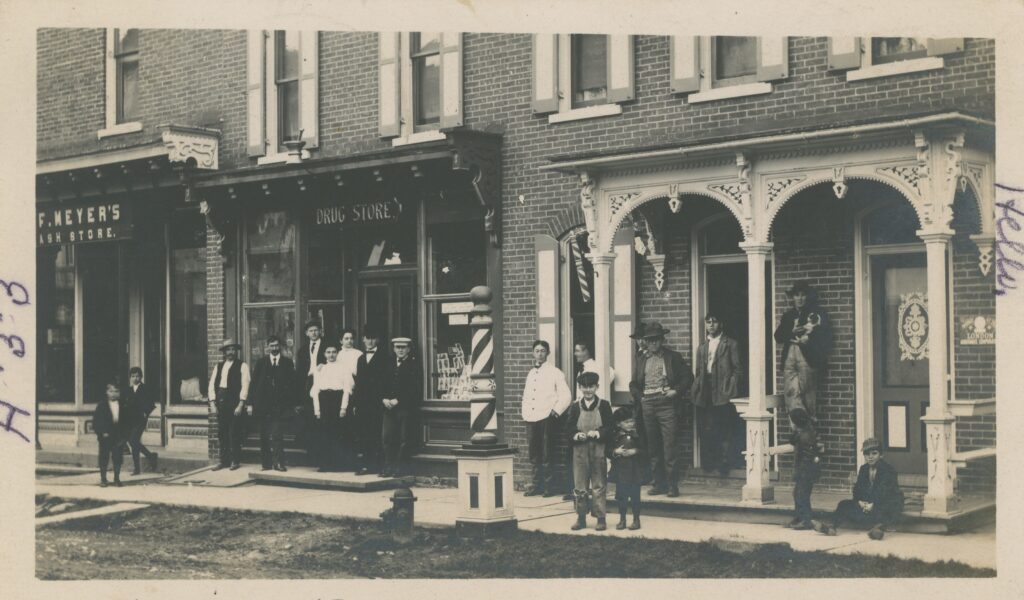 Milheim resident posed for a photograph in front of commercial establishments on Main Street, c. 1907. (Joan Brower