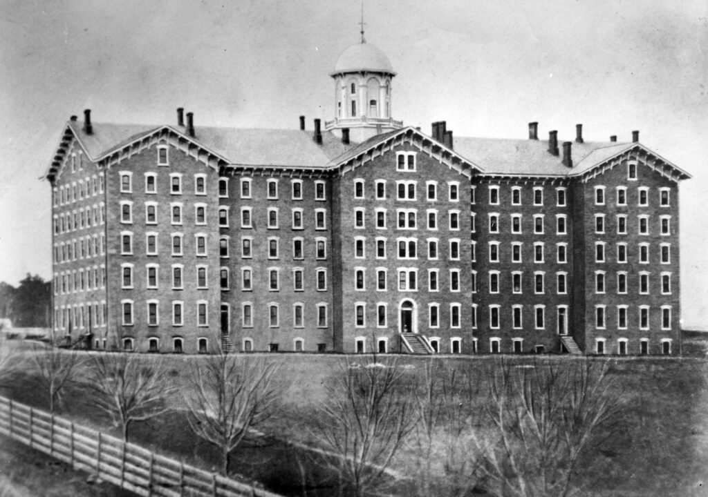The first Old Main, built in 1863, housed the student body, faculty offices, classrooms, and the library. (Penn State