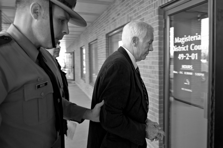 Pennsylvania State Police and Attorney General's Office officials took former football defensive coordinator Jerry