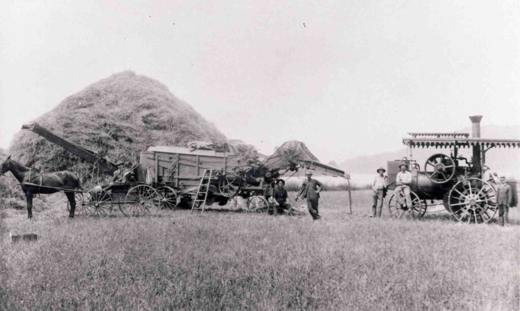 Men threshing hay on a county farm stop working to pose for a photograph. (Vonnie Henninger Collection)